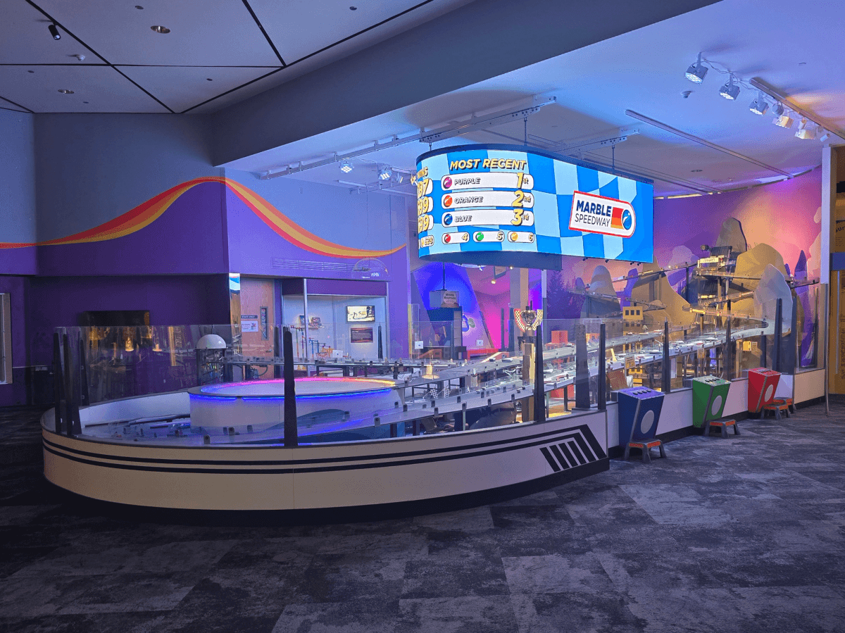 Marble Speedway — A 350-foot marble run for The Strong National Museum of Play: six custom billiard balls through 24 interactive obstacles, 4 elevators, lights, bumpers and ga…